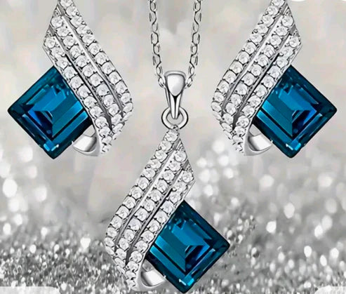 Jewelry set with blue gemstones and silver accents on a blurred background